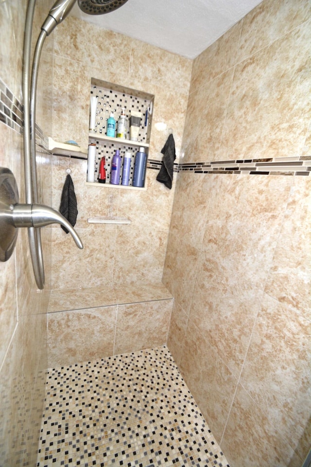 bathroom with a tile shower