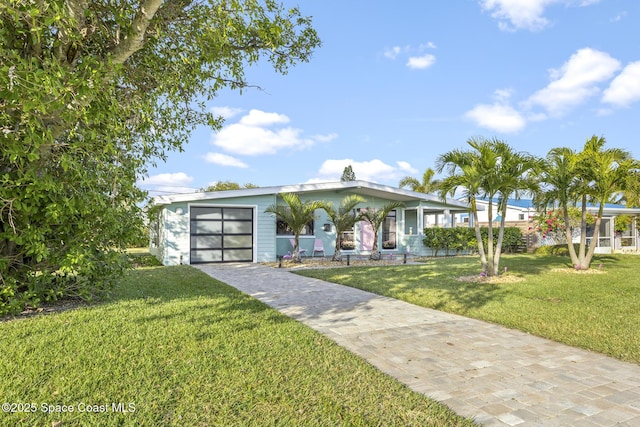 view of front facade with a garage and a front lawn