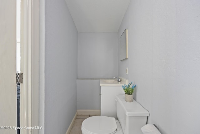 bathroom featuring vanity, tile patterned floors, and toilet