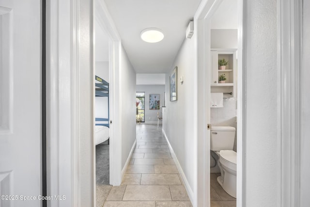 corridor featuring light tile patterned floors