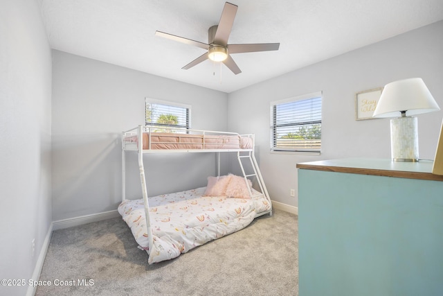 carpeted bedroom with multiple windows and ceiling fan