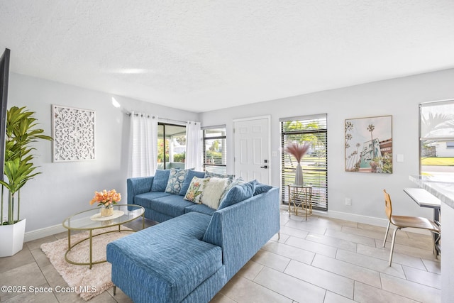 living room featuring light tile patterned flooring and a textured ceiling