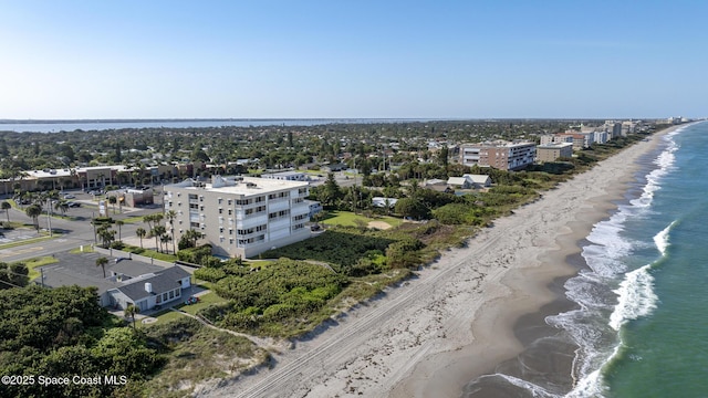 drone / aerial view with a water view and a view of the beach