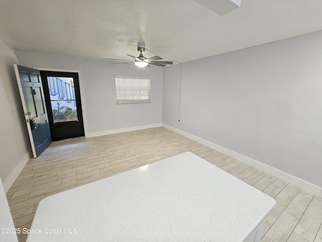 interior space with ceiling fan