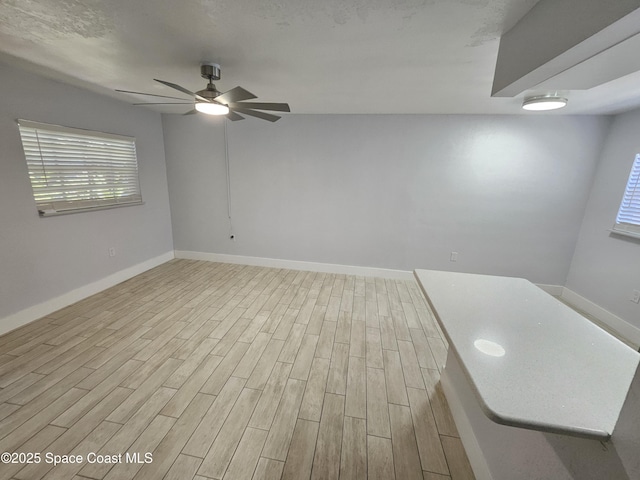 unfurnished room with light hardwood / wood-style flooring and ceiling fan