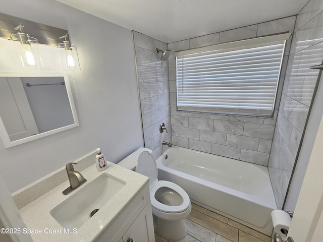 full bathroom with vanity, toilet, and tiled shower / bath