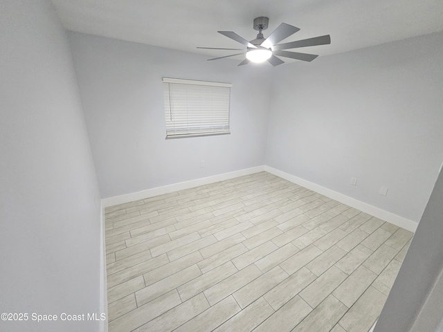 spare room with ceiling fan and light wood-type flooring