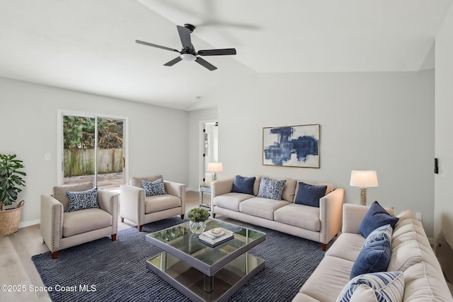 living room featuring wood-type flooring, vaulted ceiling, and ceiling fan