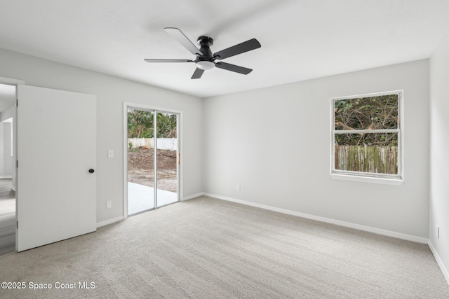 carpeted empty room featuring ceiling fan