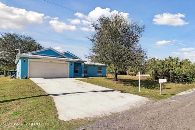 view of front of home with a garage and a front yard