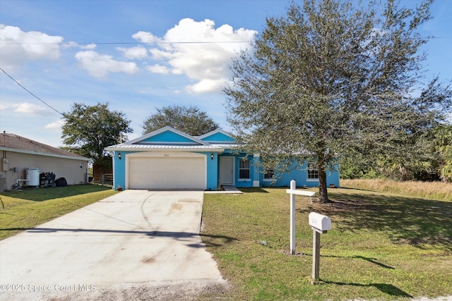 view of front of home with a garage and a front yard