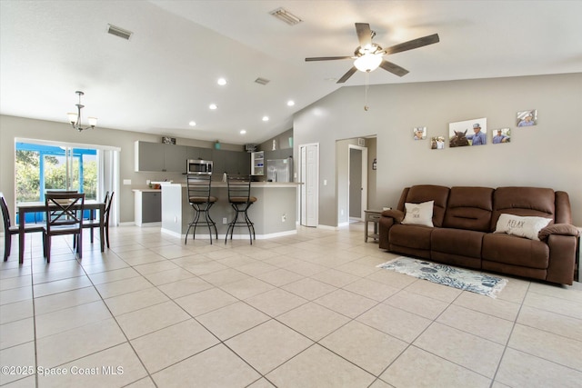 tiled living room with ceiling fan and vaulted ceiling