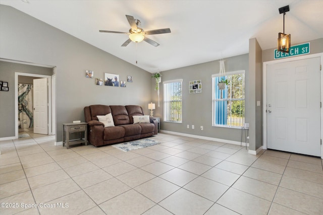 tiled living room with ceiling fan and vaulted ceiling