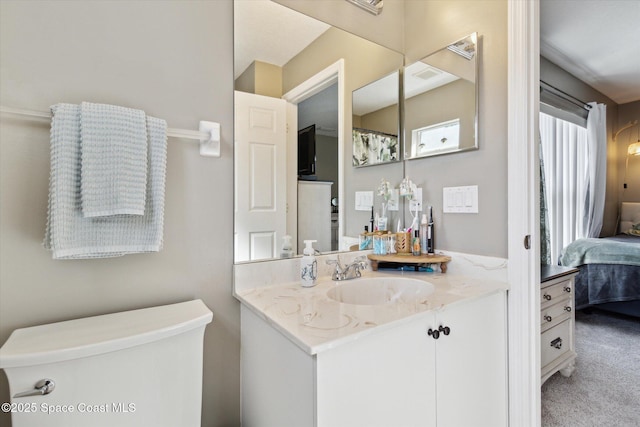 bathroom featuring vanity and toilet