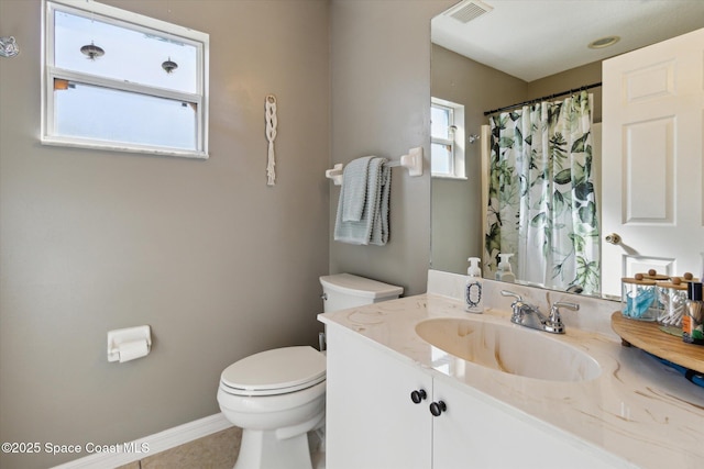 bathroom featuring tile patterned floors, vanity, and toilet