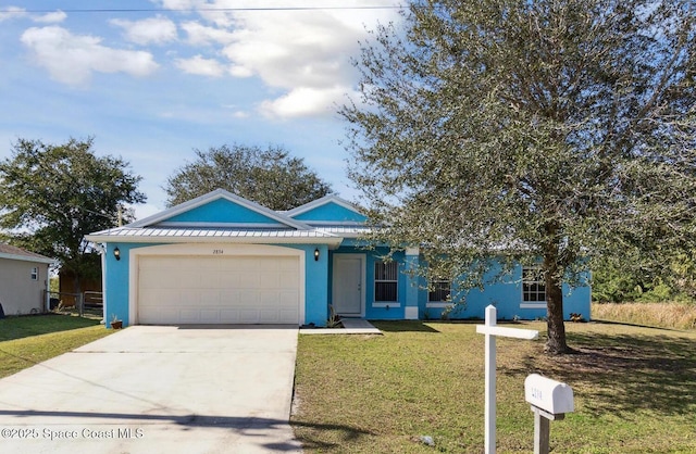 view of front of house with a garage and a front yard