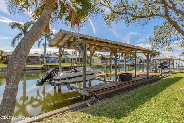 view of dock with a water view and a yard