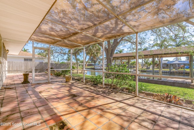 unfurnished sunroom featuring a water view