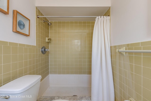 bathroom featuring tile walls, toilet, and walk in shower