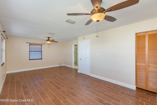 unfurnished room with a textured ceiling and ceiling fan