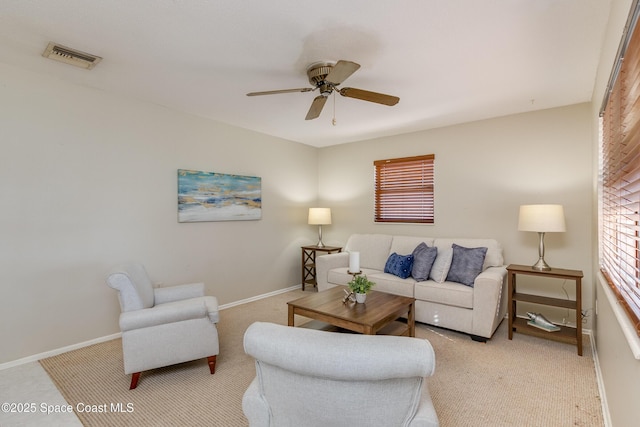 living room featuring ceiling fan and light colored carpet