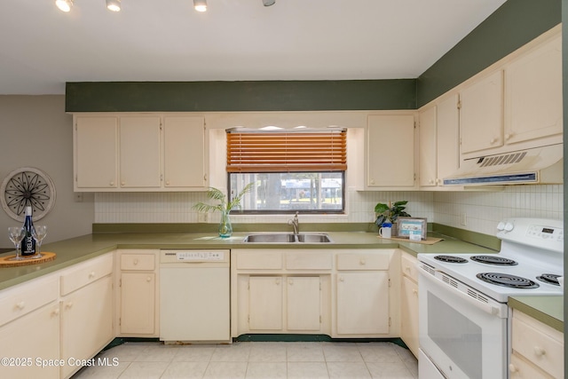 kitchen featuring sink, white appliances, and cream cabinets