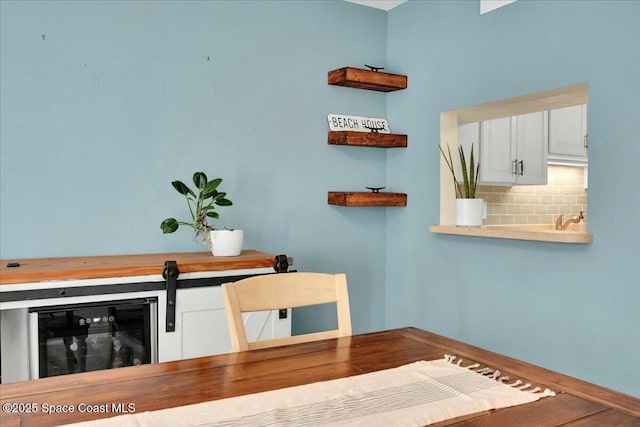 interior space with white cabinetry and backsplash