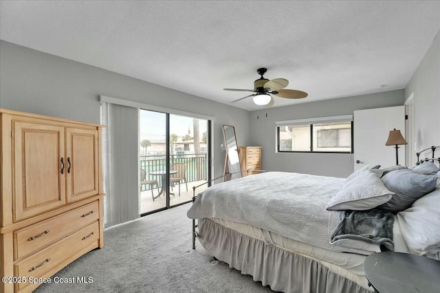 bedroom featuring a textured ceiling, light colored carpet, access to exterior, and ceiling fan