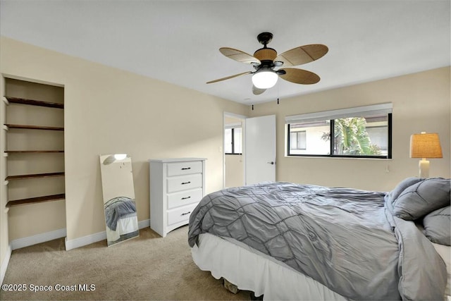 bedroom featuring ceiling fan and light colored carpet