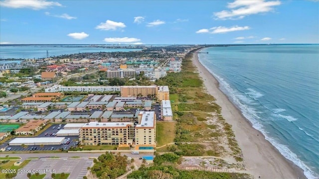 drone / aerial view featuring a beach view and a water view