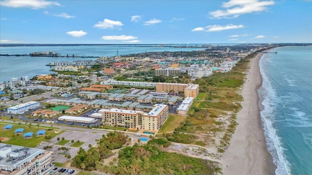 drone / aerial view with a beach view and a water view