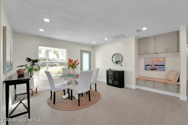 dining area with a textured ceiling