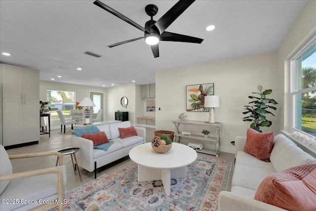 living room with a healthy amount of sunlight and ceiling fan