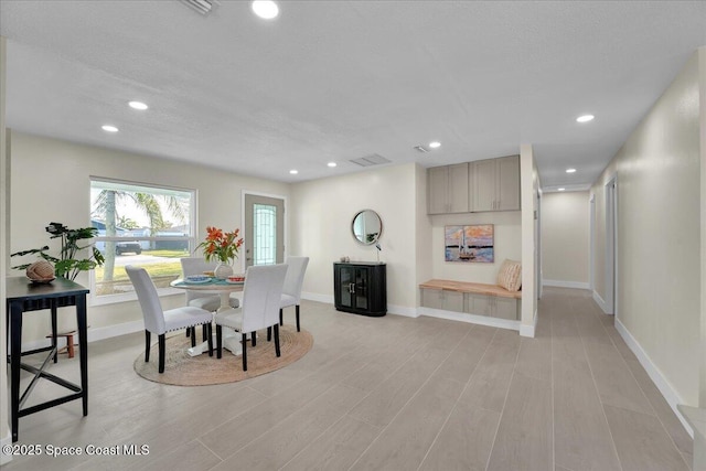 dining space with a textured ceiling