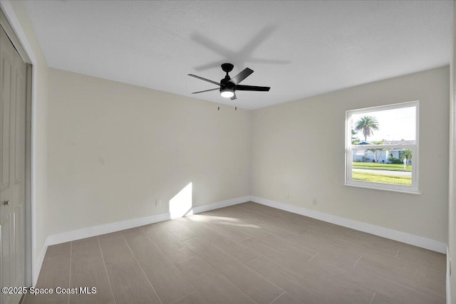 spare room with ceiling fan