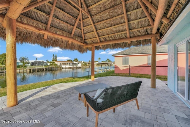 view of patio featuring a gazebo and a water view