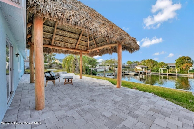 view of patio / terrace featuring a water view and a gazebo