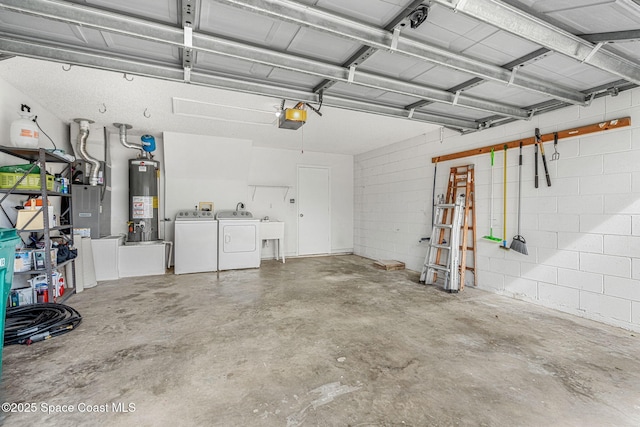 garage featuring a garage door opener, sink, heating unit, washer and dryer, and water heater