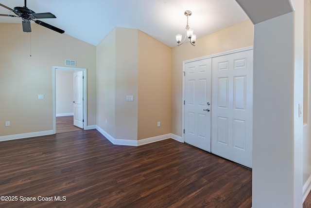 foyer featuring ceiling fan with notable chandelier, vaulted ceiling, and dark hardwood / wood-style floors