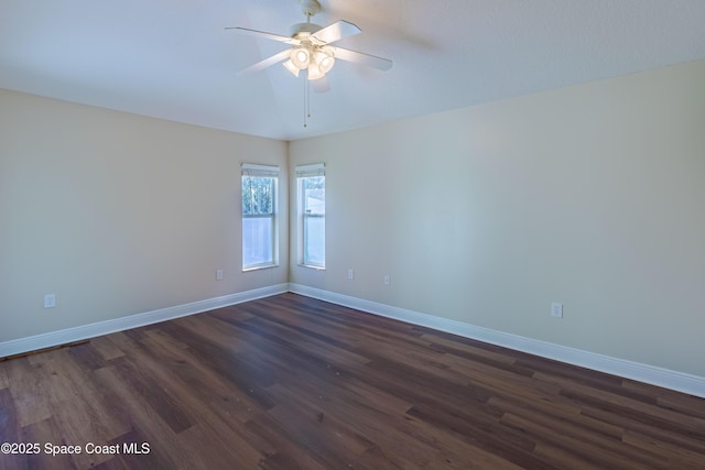 spare room with ceiling fan and dark hardwood / wood-style flooring