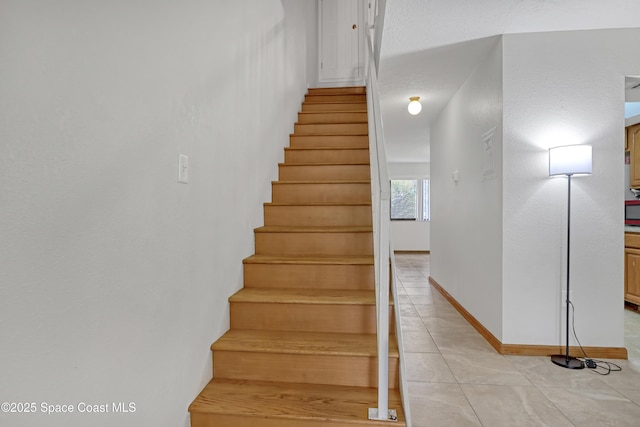 stairway with tile patterned flooring