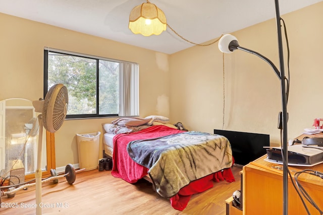 bedroom with hardwood / wood-style flooring