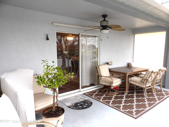 interior space with ceiling fan