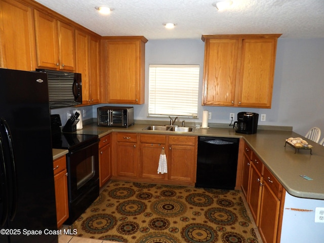 kitchen featuring light tile patterned floors, sink, and black appliances