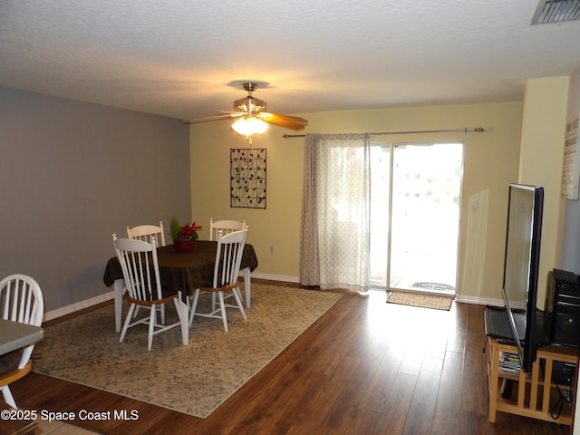 dining area with hardwood / wood-style floors and ceiling fan