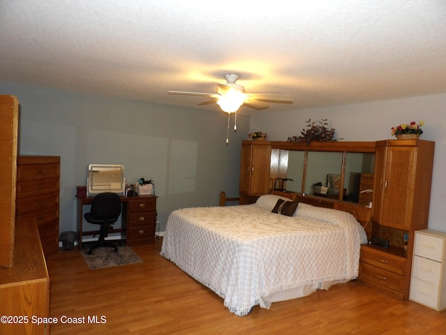 bedroom featuring ceiling fan and light hardwood / wood-style floors