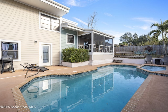 view of swimming pool featuring area for grilling, a patio area, a sunroom, and an in ground hot tub