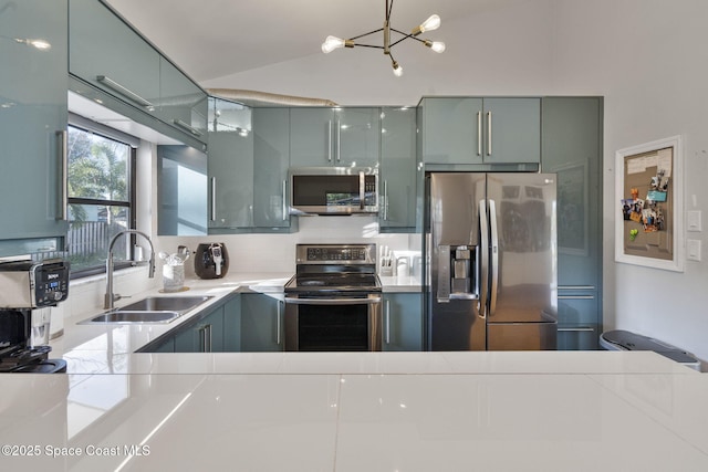 kitchen with stainless steel appliances, vaulted ceiling, and sink