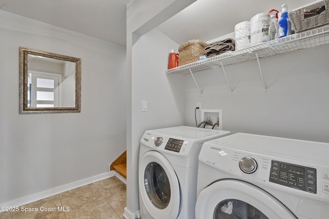 laundry area with light tile patterned floors and washing machine and clothes dryer