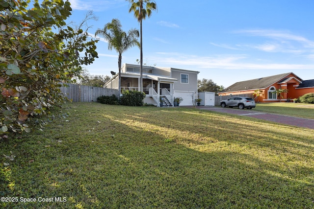 view of front of house featuring a garage and a front yard